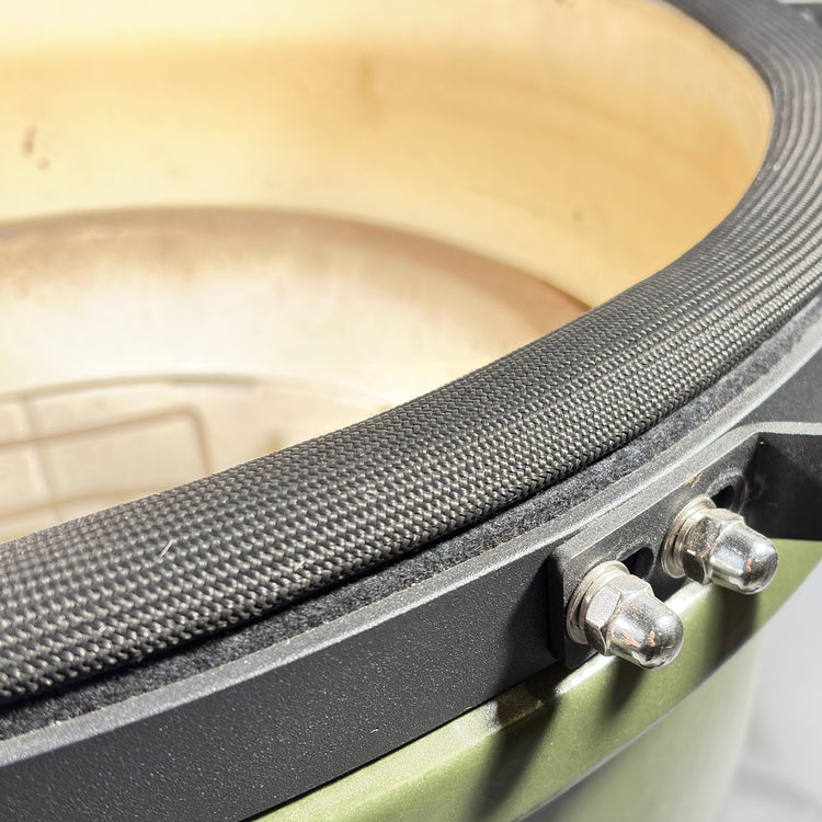 Close-up of the black mesh gasket fitted around a kamado grill rim.