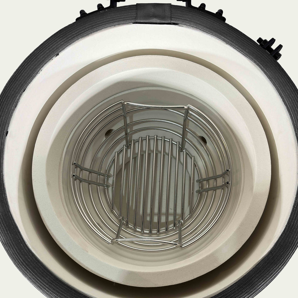 Overhead view inside the V2 Mini showing the ceramic fire bowl and charcoal basket.