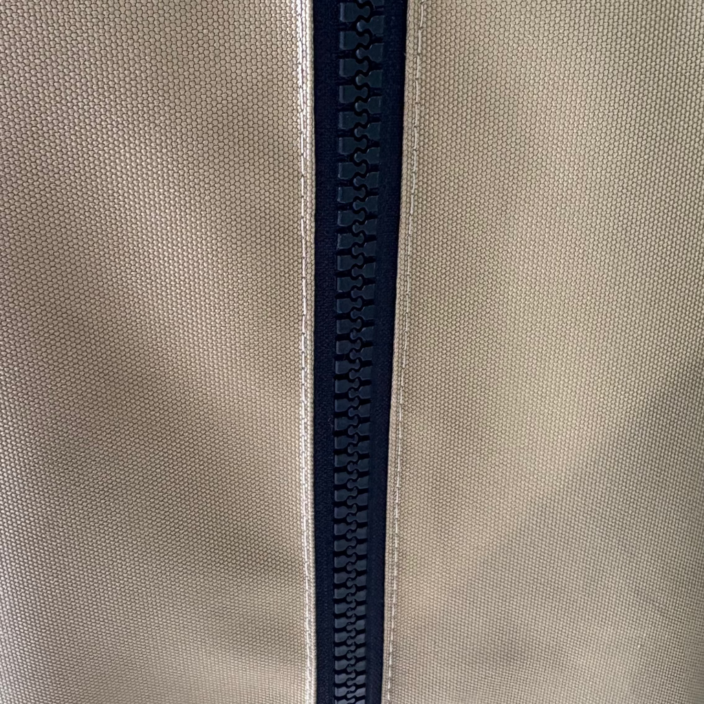 Close-up of the vertical zip and stitching on a khaki kamado cover.