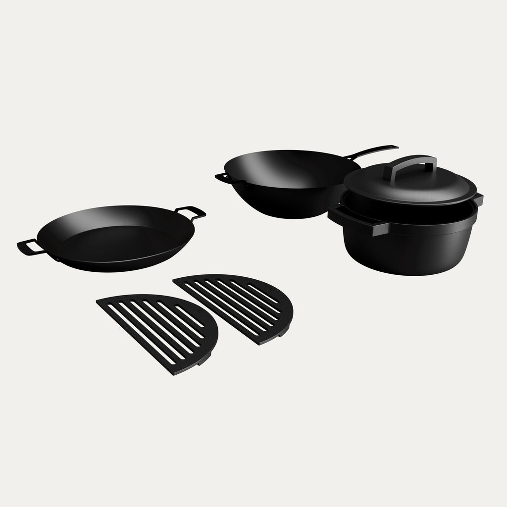 KAMA GEAR cookware bundle showing wok, paella pan, SmokePot and two half-moon grates.