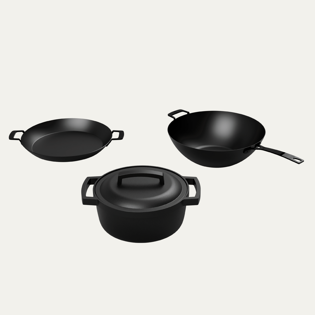 KAMA GEAR wok, paella pan and lidded SmokePot arranged together.