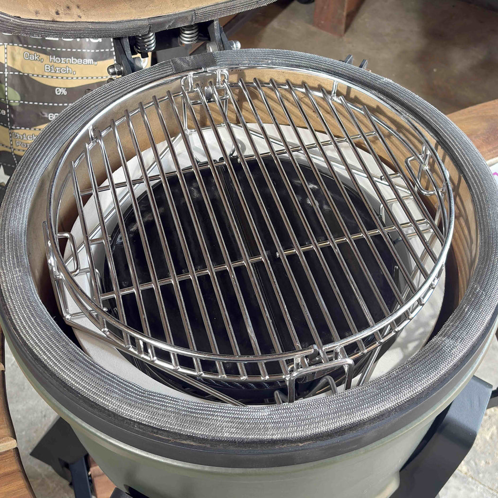 Open V2 Mini Kamado showing its stainless steel cooking grate and support rack.