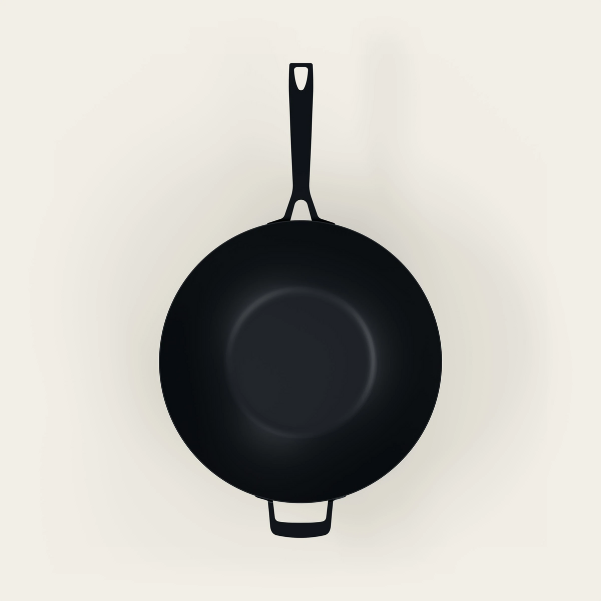 A black cast iron wok shown from a top-down perspective on a light beige background.
